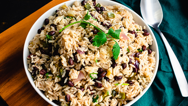 A white bowl containing a mix of rice pilaf and black beans